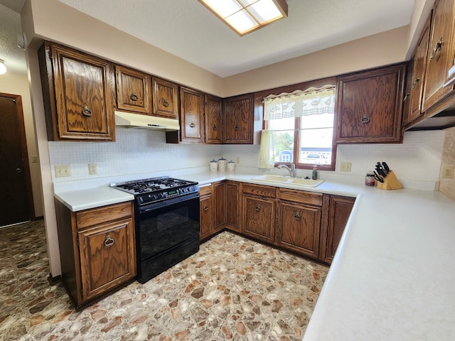 25 3rd Ave NE, Plainview, MN 55964 - kitchen featuring black range with gas cooktop, under cabinet range hood, a sink, and tasteful backsplash