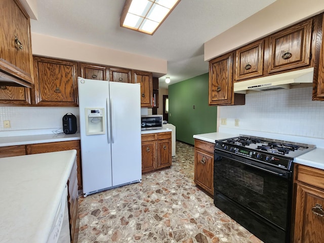 25 3rd Ave NE, Plainview, MN 55964 - kitchen featuring white refrigerator with ice dispenser, gas stove, under cabinet range hood, stainless steel microwave, and backsplash