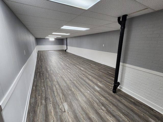 25 3rd Ave NE, Plainview, MN 55964 - finished basement featuring a paneled ceiling, wood finished floors, brick wall, and baseboards