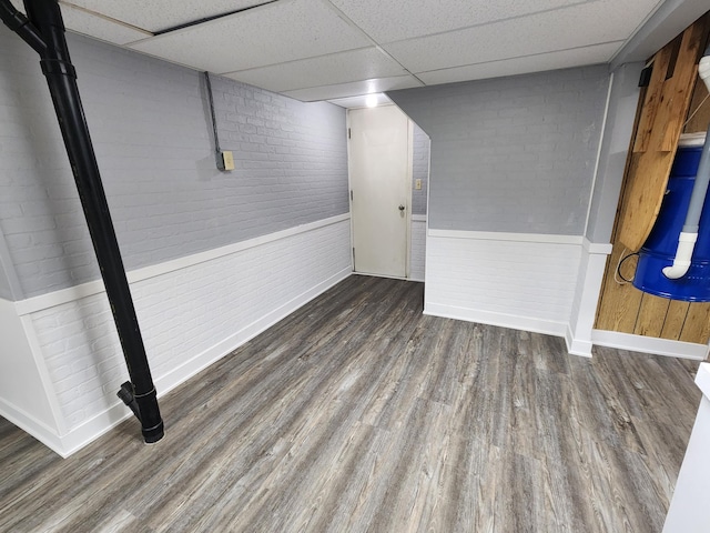 25 3rd Ave NE, Plainview, MN 55964 - finished basement with baseboards, wood finished floors, a paneled ceiling, wainscoting, and brick wall