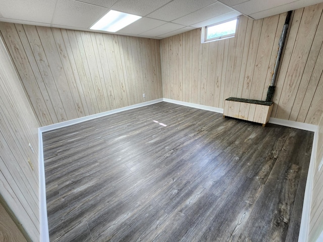 25 3rd Ave NE, Plainview, MN 55964 - basement featuring radiator heating unit, wood finished floors, wood walls, a paneled ceiling, and baseboards