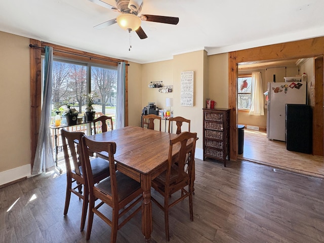 20 1st St, Luck, WI 54853 - dining space with a ceiling fan, wood finished floors, crown molding, and baseboards