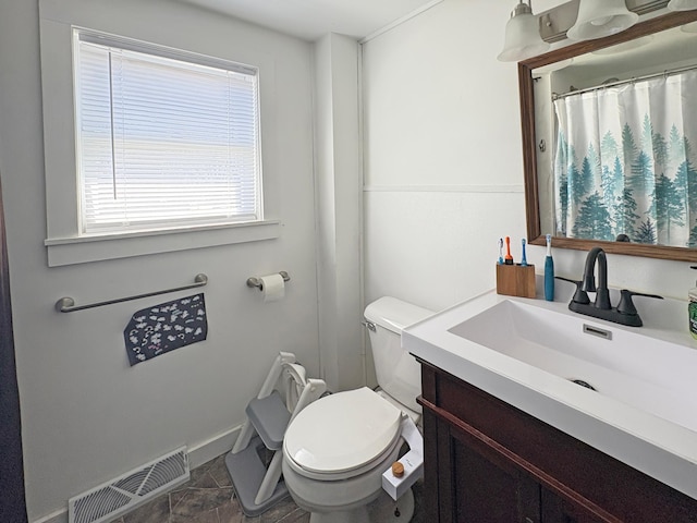 20 1st St, Luck, WI 54853 - bathroom featuring toilet, vanity, and baseboards
