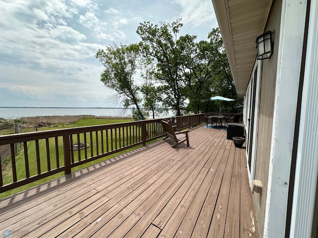 44556 Mcgowan Estates Rd, Rush Lake Twp, MN 56571 - wooden deck featuring outdoor dining area and a lawn