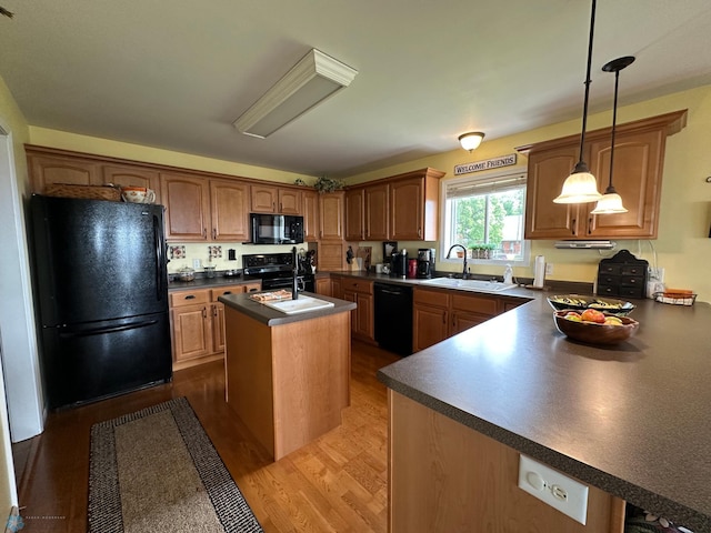 44556 Mcgowan Estates Rd, Rush Lake Twp, MN 56571 - kitchen with black appliances, a sink, dark countertops, an island with sink, and dark wood-style floors