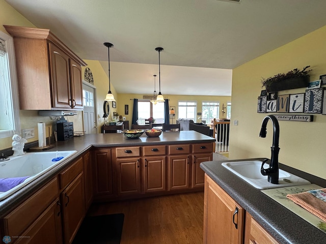 44556 Mcgowan Estates Rd, Rush Lake Twp, MN 56571 - kitchen featuring dark wood-style flooring, a peninsula, open floor plan, a sink, and dark countertops