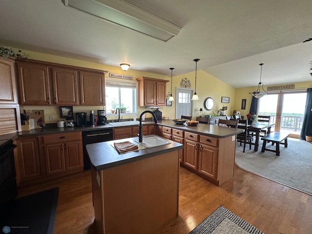 44556 Mcgowan Estates Rd, Rush Lake Twp, MN 56571 - kitchen with dark countertops, a sink, an island with sink, a peninsula, and vaulted ceiling