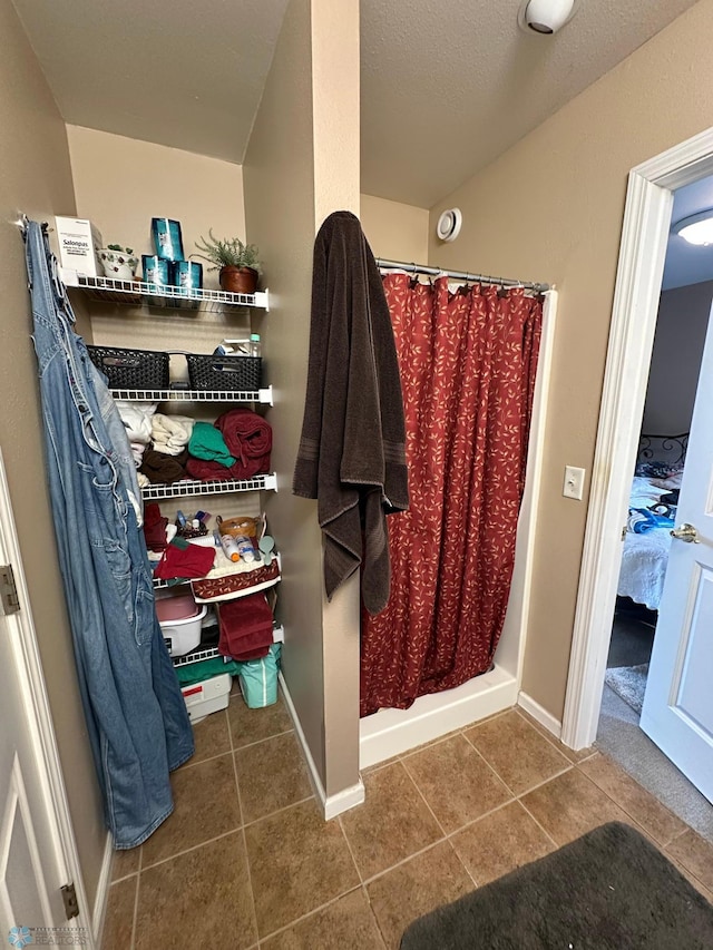 44556 Mcgowan Estates Rd, Rush Lake Twp, MN 56571 - bathroom with a shower with curtain, ensuite bath, tile patterned flooring, and baseboards