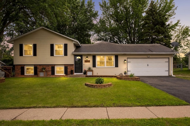15350 Drexel Way, Apple Valley, MN 55124 - split level home with driveway, a front lawn, a garage, and brick siding