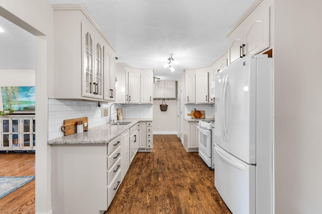 15350 Drexel Way, Apple Valley, MN 55124 - kitchen featuring white appliances, glass insert cabinets, dark wood-type flooring, white cabinetry, and backsplash