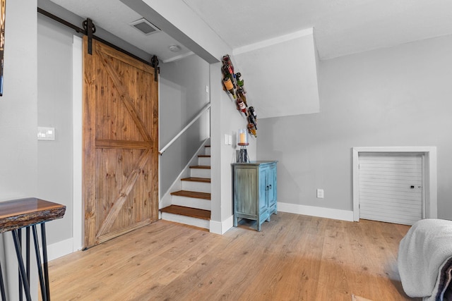 15350 Drexel Way, Apple Valley, MN 55124 - staircase featuring a barn door and wood finished floors