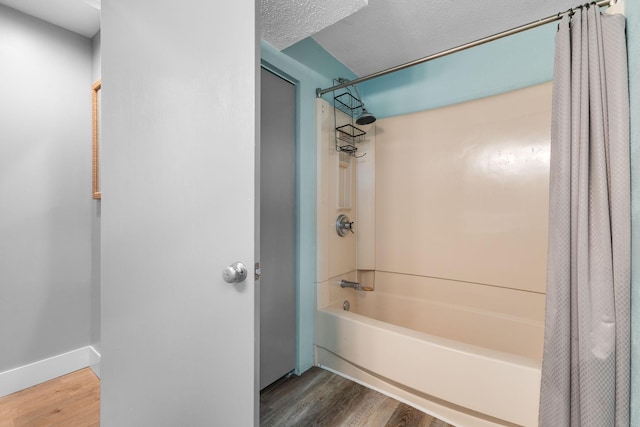 15350 Drexel Way, Apple Valley, MN 55124 - bathroom with shower / bathtub combination with curtain and wood finished floors