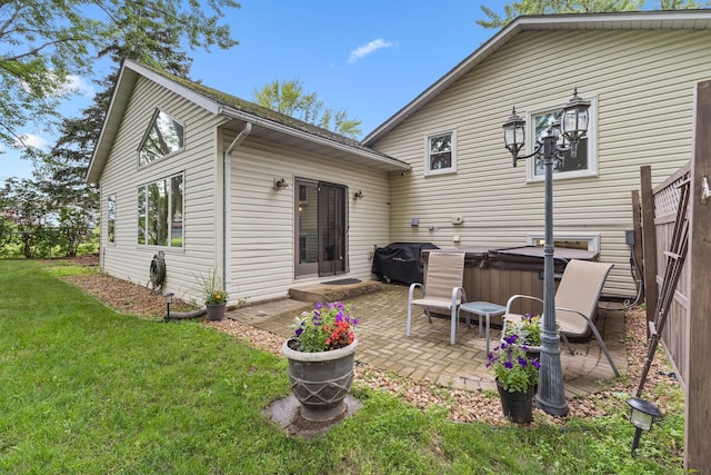 15350 Drexel Way, Apple Valley, MN 55124 - back of property featuring a hot tub, a patio area, and a lawn