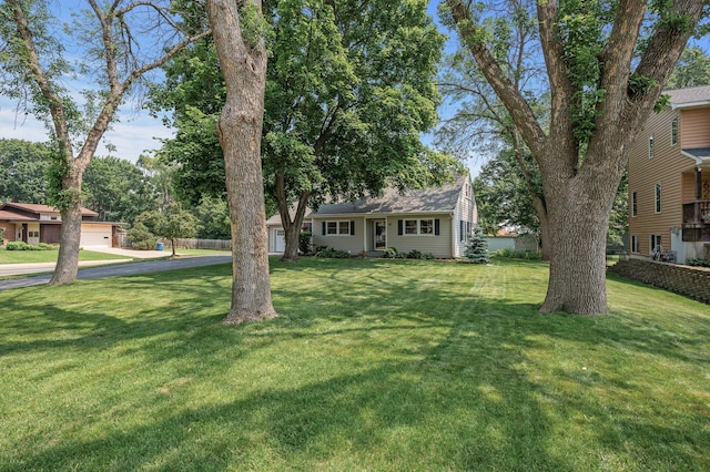 611 Sumter Ave S, Golden Valley, MN 55426 - view of front of house with driveway, a front yard, and an attached garage