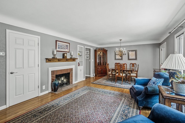 611 Sumter Ave S, Golden Valley, MN 55426 - living area with wood finished floors, a chandelier, a brick fireplace, and built in features
