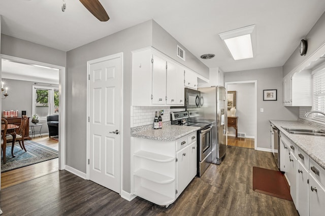 611 Sumter Ave S, Golden Valley, MN 55426 - kitchen with stainless steel appliances, white cabinets, dark wood finished floors, and backsplash