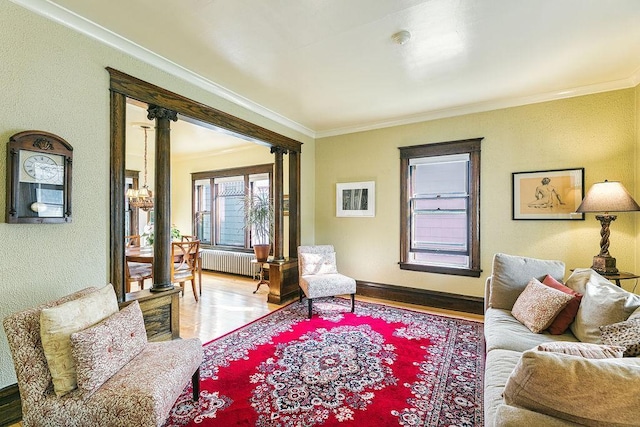 1311 Monroe St NE, Minneapolis, MN 55413 - living area featuring radiator, crown molding, wood finished floors, and a textured wall