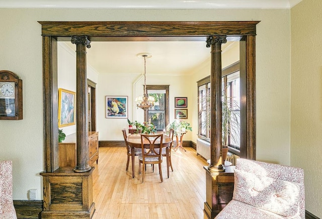 1311 Monroe St NE, Minneapolis, MN 55413 - dining room featuring light wood-style flooring, crown molding, baseboards, and a chandelier