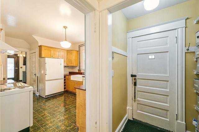 1311 Monroe St NE, Minneapolis, MN 55413 - kitchen with freestanding refrigerator, washer / clothes dryer, dark flooring, a sink, and decorative light fixtures