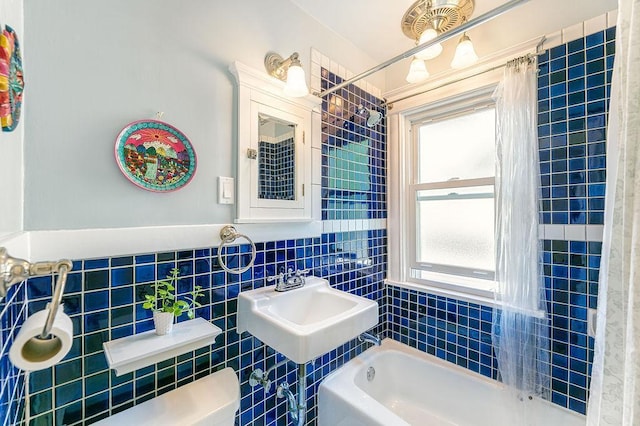 1311 Monroe St NE, Minneapolis, MN 55413 - bathroom featuring curtained shower, toilet, a bathtub, tile walls, and a sink