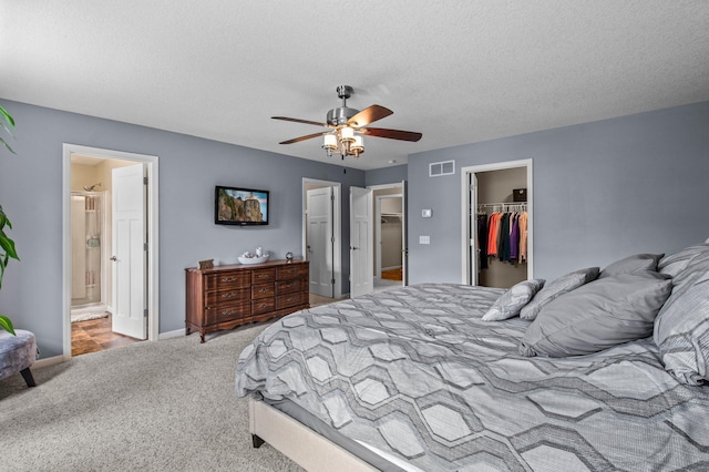 8607 Portage Ln E, Shakopee, MN 55379 - bedroom with a walk in closet, carpet flooring, a closet, baseboards, and ceiling fan