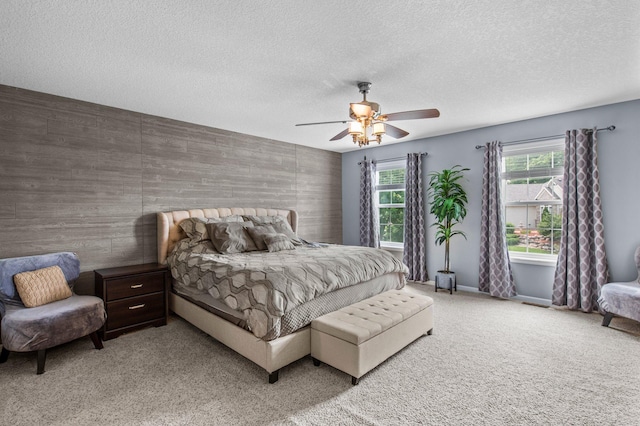 8607 Portage Ln E, Shakopee, MN 55379 - carpeted bedroom featuring an accent wall, a ceiling fan, a textured ceiling, and baseboards
