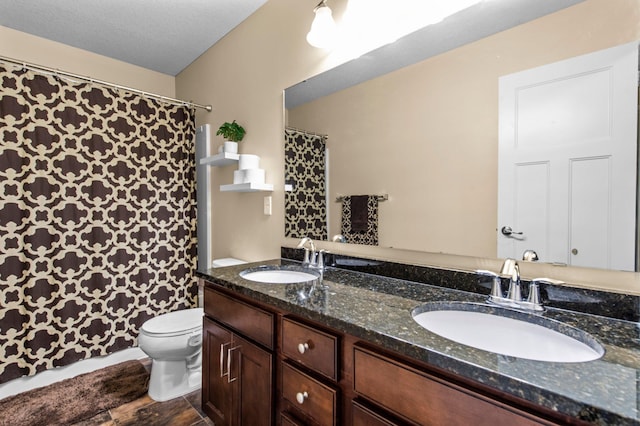 8607 Portage Ln E, Shakopee, MN 55379 - bathroom with toilet, double vanity, curtained shower, and wood finished floors