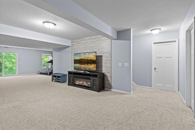 8607 Portage Ln E, Shakopee, MN 55379 - unfurnished living room featuring a textured ceiling, carpet, a glass covered fireplace, and baseboards