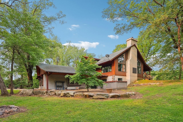 9590 Woodhill Blvd, New Market Twp, MN 55044 - rear view of house featuring a chimney, a yard, and a shingled roof