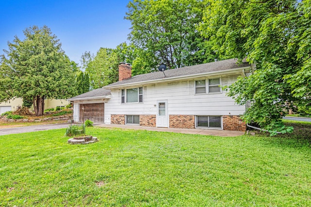 5421 Church Rd, Mound, MN 55364 - split foyer home with a chimney, a front yard, asphalt driveway, and a garage