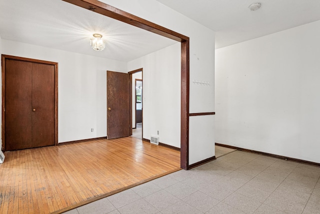5421 Church Rd, Mound, MN 55364 - unfurnished room featuring a smoke detector, hardwood / wood-style floors, baseboards, and a chandelier