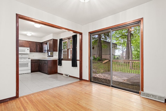 5421 Church Rd, Mound, MN 55364 - doorway with a sink, light wood-type flooring, and baseboards