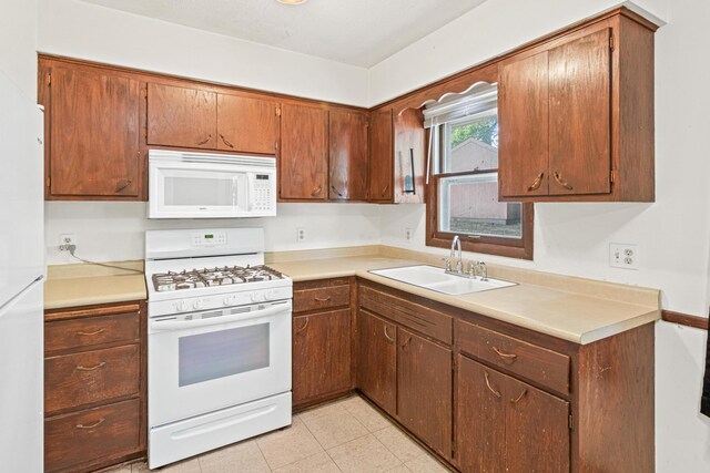 5421 Church Rd, Mound, MN 55364 - kitchen with white appliances, a sink, light countertops, and brown cabinetry