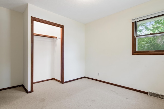 5421 Church Rd, Mound, MN 55364 - unfurnished bedroom with light carpet, baseboards, and a closet
