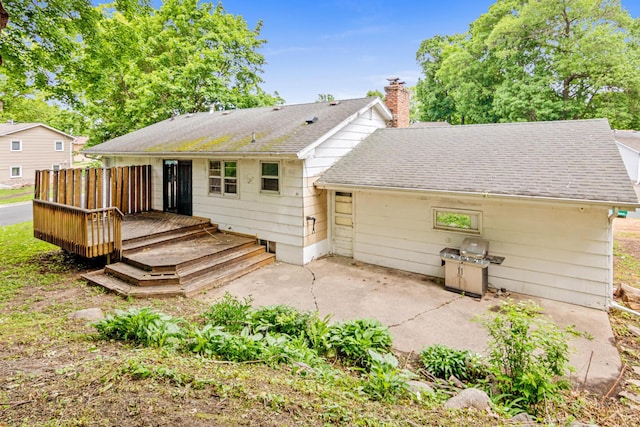 5421 Church Rd, Mound, MN 55364 - back of house featuring a patio area, a chimney, a wooden deck, and a shingled roof