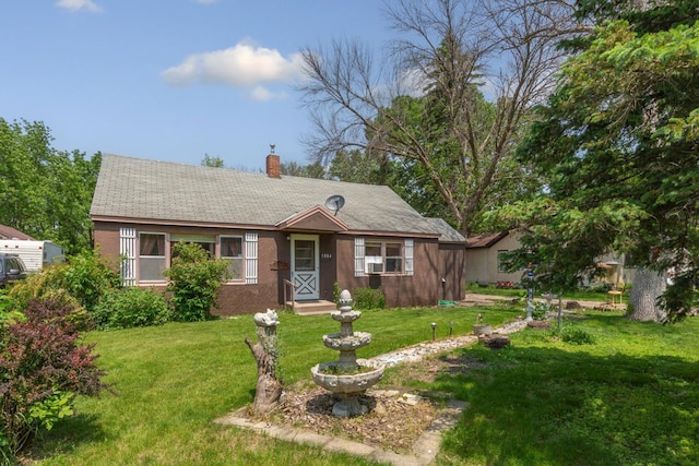 1034 8th St NW, Faribault, MN 55021 - view of front of home with a chimney, a front lawn, and cooling unit