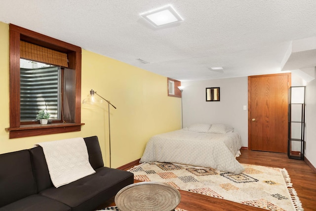 246 Griggs St S, Saint Paul, MN 55105 - bedroom featuring wood finished floors and a textured ceiling