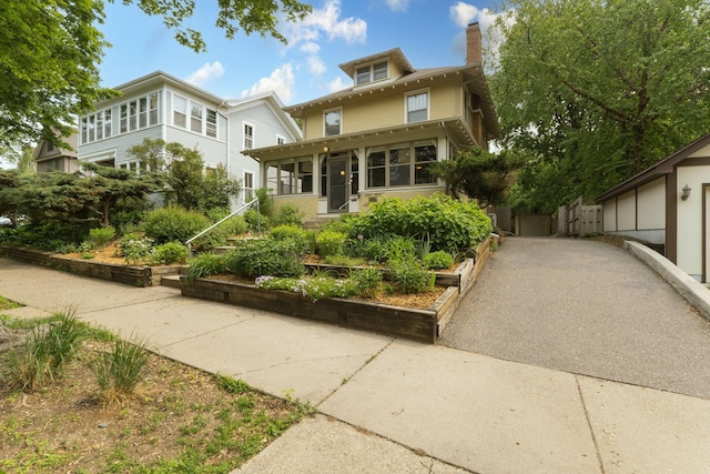 2441 Grand Ave S, Minneapolis, MN 55405 - american foursquare style home featuring a chimney and a sunroom
