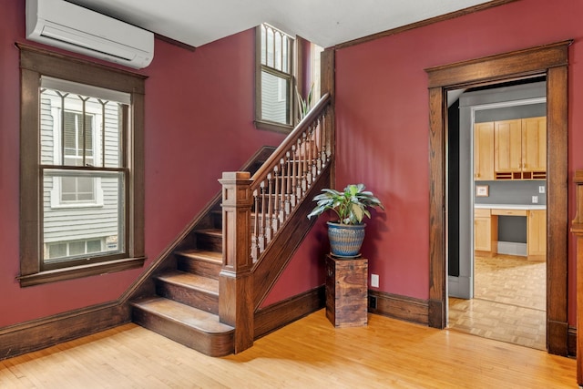 2441 Grand Ave S, Minneapolis, MN 55405 - stairway with a wall unit AC, wood finished floors, and baseboards