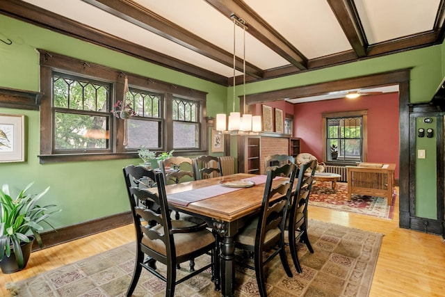 2441 Grand Ave S, Minneapolis, MN 55405 - dining space with beamed ceiling, wood finished floors, radiator heating unit, and baseboards