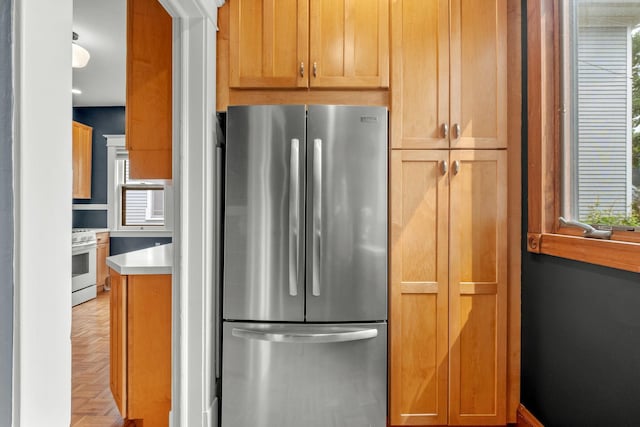 2441 Grand Ave S, Minneapolis, MN 55405 - kitchen featuring freestanding refrigerator, white range with gas stovetop, plenty of natural light, and light countertops