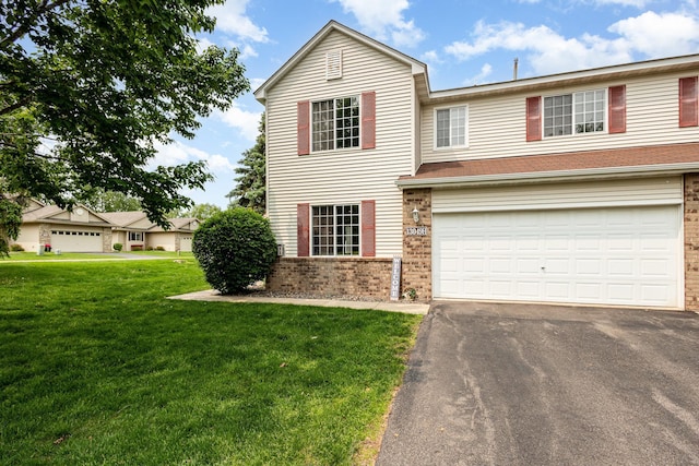 13049 Europa Trail Way N Unit H, Hugo, MN 55038 - traditional-style home featuring brick siding, asphalt driveway, an attached garage, and a front yard