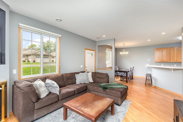 13049 Europa Trail Way N Unit H, Hugo, MN 55038 - living room with a chandelier, light wood-style flooring, recessed lighting, and a textured ceiling