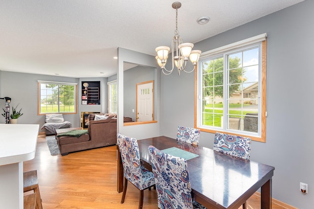 13049 Europa Trail Way N Unit H, Hugo, MN 55038 - dining area featuring a chandelier and light wood-style flooring