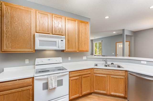 13049 Europa Trail Way N Unit H, Hugo, MN 55038 - kitchen with white appliances, light countertops, recessed lighting, light wood-style flooring, and a textured ceiling