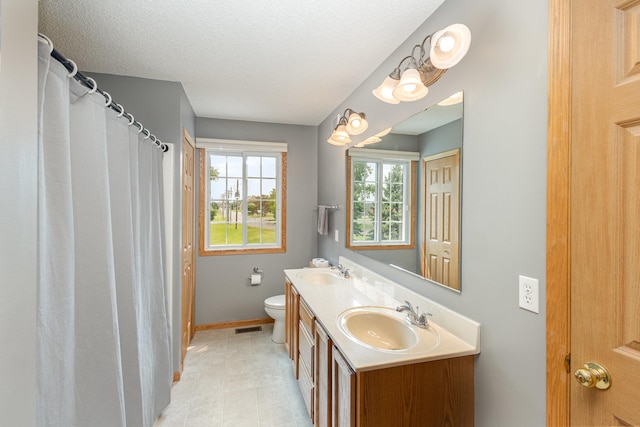 13049 Europa Trail Way N Unit H, Hugo, MN 55038 - bathroom with double vanity and a textured ceiling