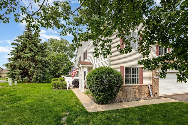 13049 Europa Trail Way N Unit H, Hugo, MN 55038 - view of property exterior featuring brick siding, a lawn, and a garage