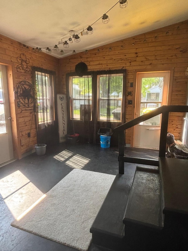 613 13th St SW, Willmar, MN 56201 - foyer entrance featuring lofted ceiling and wooden walls