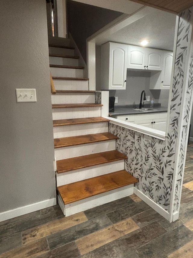 613 13th St SW, Willmar, MN 56201 - staircase featuring baseboards and wood finished floors