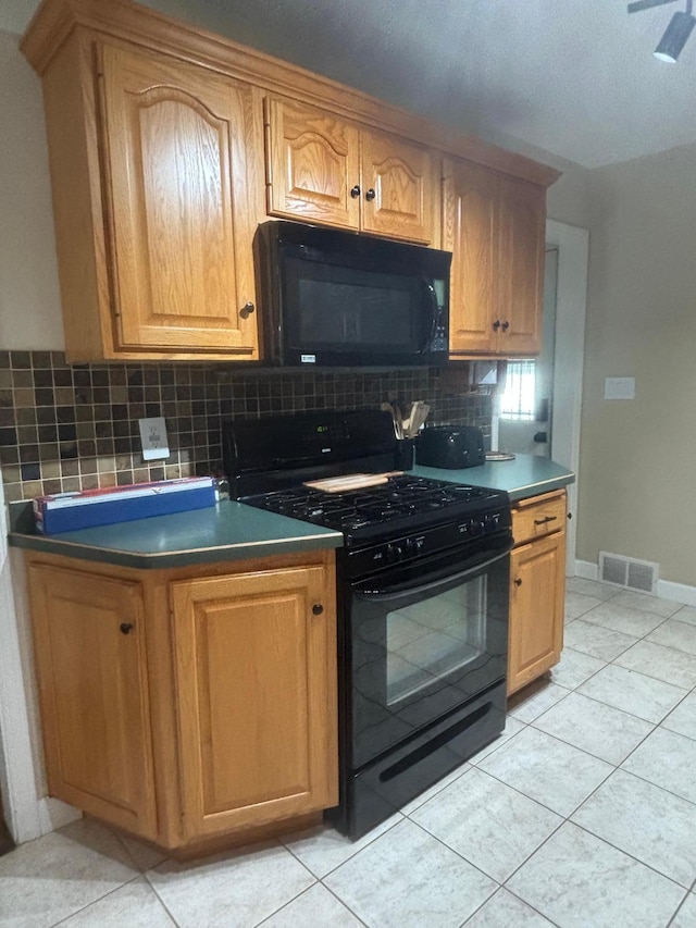 613 13th St SW, Willmar, MN 56201 - kitchen with black appliances, backsplash, light tile patterned flooring, and dark countertops
